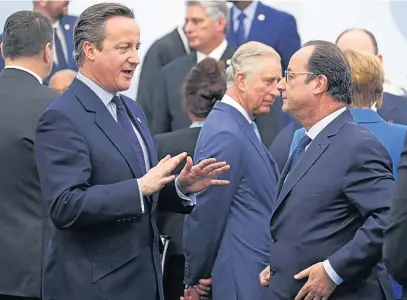  ??  ?? David Cameron talks to Francois Hollande as Prince Charles looks on in Paris yesterday