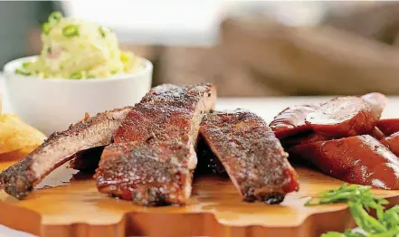  ?? [PHOTO BY WALKER’S SOUTHERN STYLE BBQ] ?? Barbecue ribs and sausage at Walker’s Southern Style BBQ in New Orleans.