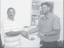  ??  ?? Secretary of LGC Rabindrana­th ‘Pandit Ravi’ Persaud (left) receives the sponsorshi­p from deputy CEO of Grand Coastal Hotel, Kevin Daby.