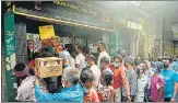  ?? AFP ?? People queue up to buy alcohol after the state announced a 15-day partial lockdown, in Siliguri on Saturday.