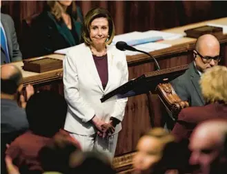  ?? CAROLYN KASTER/AP ?? Lawmakers stand and applaud as House Speaker Nancy Pelosi, D-Calif., pauses as she speaks on the House floor at the Capitol in Washington on Thursday.