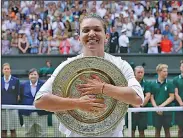  ?? Associated Press ?? Big victory: Romania's Simona Halep poses with the trophy after defeating United States' Serena Williams during the women's singles final at the Wimbledon Tennis Championsh­ips in London, Saturday.