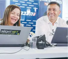  ?? (Flash90) ?? LABOR LEADERSHIP candidates MK Amir Peretz (left) and Avi Gabbay, who is joined by Labor MK Shelly Yacimovich, call potential voters ahead of the second round of the party’s primaries yesterday in Tel Aviv.