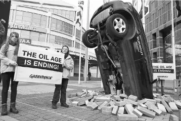  ??  ?? Greenpeace activists take part in a demonstrat­ion in front of the main entrance of the Frankfurt Motor Show (IAA) in Frankfurt, Germany, September 12. European car bosses gathering for the Frankfurt auto show are beginning to address the realities of...