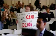  ?? PHOTO BY GARY KAZANJIAN ?? Benjamin Tuggy holds a sign while listening to speakers during the first of three public hearings on the Trump administra­tion’s proposal to roll back car-mileage standards in a region with some of the nation’s worst air pollution Monday, Sept. 24, in Fresno, Calif.