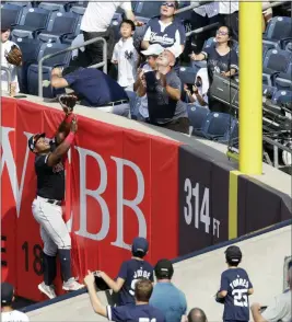  ?? KATHY WILLENS — THE ASSOCIATED PRESS ?? Yasiel Puig leaps for a two-run home run by the Yankees’ DJ LeMahieu on Aug. 18 in New York.