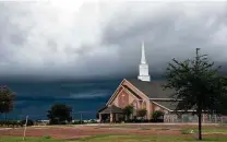  ?? Danny Zaragoza / Laredo Morning Times file photo ?? Rain clouds loom over First Baptist Church in Laredo. When it rains Sunday mornings, crime goes up, a UTSA study says.