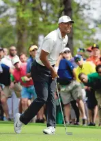  ?? CHRIS CARLSON/ASSOCIATED PRESS ?? Tiger Woods shot a 3-over 75 Friday, which was good enough to make the cut. But he is well off the pace of leader Patrick Reed.