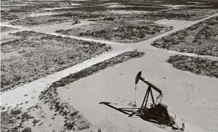  ?? Daniel Acker / Bloomberg ?? Pump jacks operate in the Permian Basin. Oil’s recent rally will likely boost output by U.S. shale producers. U.S. production has rebounded 1.2 million barrels per day in December.