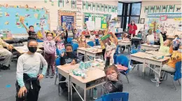  ?? FILE ?? Evergreen Park first graders show books they received from Evergreen Park Community High School Service Club members before winter break.