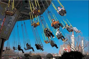  ?? — ap ?? Improved sentiment: Visitors enjoy a ride at an amusement park during the week-long Lunar New year holiday in beijing. during that period, domestic tourism revenue rose 30% y-o-y to 375.84 billion yuan (us$55.62bil or rm237.3bil).