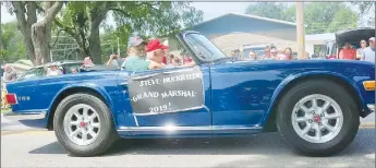  ?? Westside Eagle Observer/SUSAN HOLLAND ?? Local photograph­er Steve Huckriede, grand marshal of the “Making Memories” 2019 Gravette Day parade, smiles for the camera as he rides along the parade route. Huckriede was driven in the parade by 2010 grand marshal Ron Teasley.