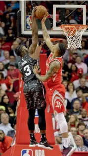  ?? — AFP ?? Houston Rockets’ Gerald Green ( right) blocks a shot from Brandon Paul of the San Antonio Spurs at the Toyota Center in their NBA match in Houston on Monday. The Rockets won 109- 93.