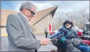  ?? (Special to NWA Democrat-Gazette/Alexus Underwood) ?? Bella Vista Mayor John Flynn reads a certificat­e of celebratio­n to Eales as she grins from the back of a motorcycle, a place she looked very comfortabl­e to be sitting.