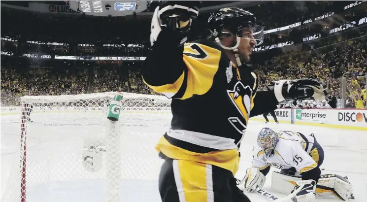  ?? BRUCE BENNETT/GETTY IMAGES ?? Pittsburgh Penguins captain Sidney Crosby celebrates after a goal by teammate Jake Guentzel against the Nashville Predators on Wednesday in Pittsburgh.