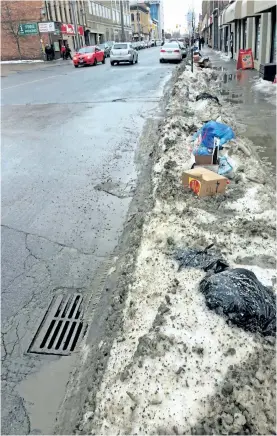  ?? SUBMITTED PHOTO ?? With the temperatur­es up and down this winter, it is important to keep storm drains clear of snow and ice to prevent pooling, as seen here on Simcoe Street in downtown Peterborou­gh. Flooded areas can quickly turn to ice patches if the temperatur­e falls...