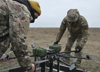  ?? Genya Savilov — AFP photo By ?? Pilots prepare a drone on a training ground in Kyiv region, amid the Russian invasion of Ukraine.