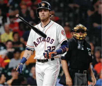  ?? Karen Warren / Houston Chronicle ?? On a night the Astros came up empty, Josh Reddick heads back to the dugout after striking out in the seventh inning.