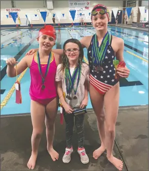  ?? Submitted photo ?? MAKING A SPLASH: Members of the Hot Springs YMCA Seals display their awards from the Paul Blair invitation­al meet. Aubrey Schmitt, center, won two events and was the high-point award winner for the 8-and-under division while Audrey Simons, left, and...