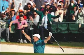  ?? The Associated Press ?? Rory McIlroy, of Northern Ireland, reacts after holing out from the bunker for a birdie during the final round at the Masters golf tournament on April 10 in Augusta, Ga.