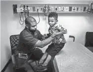  ?? MARK ?? Ty Thompson helps his son Trey Thompson onto an examining table at St. Jude Children’s Research Hospital, where Trey, 6, is treated for sickle cell anemia. Many patients who do well in childhood have problems as they grow older, and the level of care...