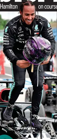  ?? REUTERS ?? Top of the world: Lewis Hamilton celebrates by climbing on to his Mercedes after his dominant victory