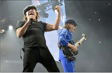  ?? ASSOCIATED PRESS FILE PHOTOS ?? Brian Johnson, left, and Angus Young, of AC/DC, perform on the Rock or Bust Tour on Feb. 17, 2016, in Chicago. After 47years, the band released its 17th studio album, “Power Up,” on Nov. 13.