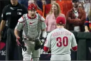  ?? AP PHOTO / SUE OGROCKI ?? Phillies catcher J.T. Realmuto, left, celebratin­g the final out recorded by pitcher David Robertson in Game 1of the World Series, was named an NL Gold Glove Award winner Tuesday.