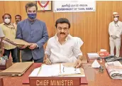  ?? — PTI ?? Newly sworn-in Tamil Nadu Chief Minister M.K. Stalin affixes his first signature on a file, at his office in the Secretaria­t, in Chennai, on Friday.