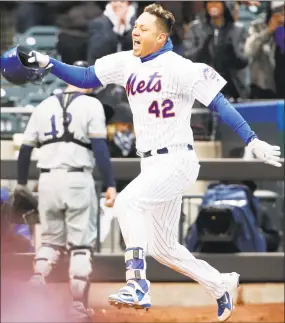  ?? Kathy Willens / Associated Press ?? Wilmer Flores celebrates his ninth-inning walk-off home run in Sunday’s game against the Brewers in New York.