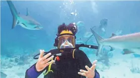  ?? PROVIDED BY DISCOVERY ?? Brad Paisley is surrounded by reef sharks.