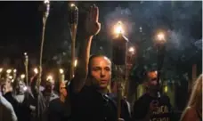  ?? EDU BAYER/NEW YORK TIMES ?? White nationalis­ts rally around a statue of Robert E. Lee in Charlottes­ville.