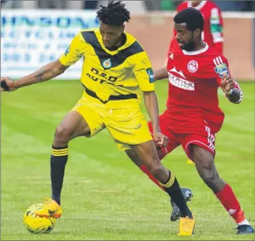  ?? Picture: Gary Browne FM4923185 ?? Ashford’s Tyrell Richardson-Brown closed down by former United player Ryan Palmer during Saturday’s match at Hythe