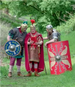  ??  ?? Preserving the past: three ‘Roman’ soldiers walk the length of the Antonine Wall, a turf barrier between the Firths of Clyde and Forth.