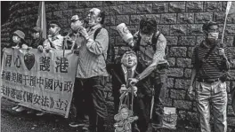  ?? ISAAC LAWRENCE/GETTY-AFP ?? An activist holds an effigy of President Donald Trump at a protest Saturday in Hong Kong.