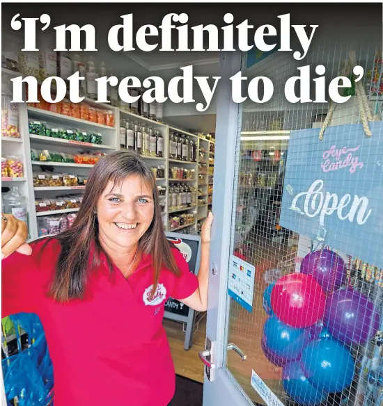  ??  ?? DETERMINED: June George outside her Burntislan­d sweet shop Aye Candy. She says she will keep on fighting despite a devastatin­g second cancer diagnosis. Picture by Kenny Smith.