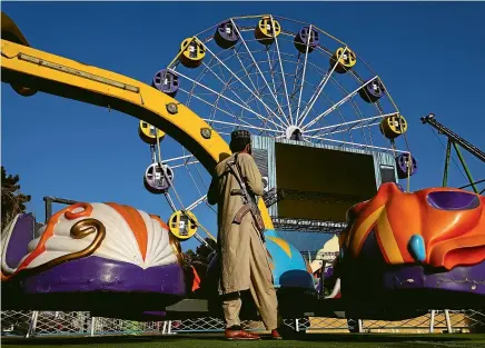  ?? AP ?? A Taliban fighter stands guard in an amusement park, in Kabul, Afghanista­n.