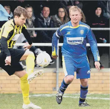  ??  ?? Karl Gibbs (blue) is a big presence in the Peterborou­gh Sports Reserve team squad.