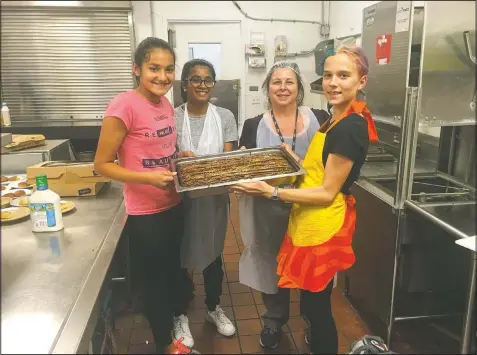  ?? (Courtesy Photo/Abode Services) ?? Jawa (from left), Anika Garikipati, Monica Quintana and Caitlin Starmer pose with freshly baked desserts inside the Abode Services homeless shelter in Fremont.