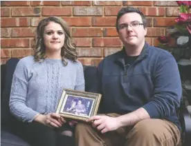  ?? STAFF PHOTO BY ERIN O. SMITH ?? Siblings Alaina Marinello, left, and Christophe­r Marinello are photograph­ed Feb. 3 holding a photo of their mom and dad, Lynda and Chris Marinello, at Alaina’s Chattanoog­a home. Lynda was the passenger in a plane crash in Soddy-Daisy earlier this year. Both Lynda Marinello and a family friend, Capt. Frank W. Davey, who was the pilot, died in the crash.