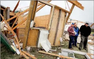  ?? NWA Democrat-Gazette/DAVID GOTTSCHALK ?? Terry Hudson (from left), Bill Grady and James Carey stand Thursday in the debris of Hudson’s workshop near Evansville in Washington County. Wednesday night’s storm destroyed the structure and did extensive damage to Hudson’s home.