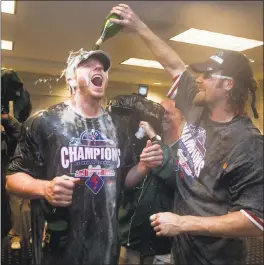  ?? FILE PHOTO BY EVAN VUCCI — ASSOCIATED PRESS ?? Roy Halladay, left, celebrates with Phillies teammate Jayson Werth after Philadelph­ia clinched the National League East in 2010.