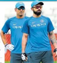  ?? AP ?? During the third ODI against Windies, MS Dhoni gave valuable inputs to skipper Virat Kohli from behind the stumps.