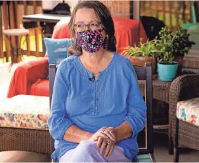  ?? PHOTOS BY CHRIS LANDSBERGE­R/THE OKLAHOMAN ?? School librarian Regina Hartley, sits on the porch at her home in Warr Acres on Tuesday and talks about her husband, Ted, who is an immunocomp­romised transplant recipient and is recovering in the hospital from COVID-19.