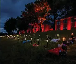  ?? Photograph: APF via Getty Images ?? Shoes, flowers, and stuffed animals sit outside the former Kamloops Indian school near to where the remains of the bodies of 215 children were found