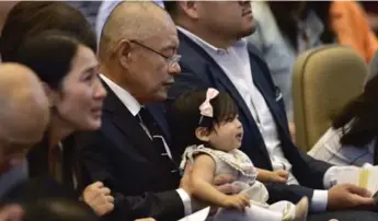  ?? FRANK GUNN/THE CANADIAN PRESS ?? Hyeon Soo Lim holds his granddaugh­ter at a church service Sunday. She was born while Lim was imprisoned.