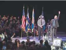  ??  ?? Chris Brown, the brother-in-law of slain El Paso County sheriff’s Deputy Micah Flick, speaks Saturday at New Life Church in Colorado Springs. “His life wasn’t taken; he gave it,” Brown said.