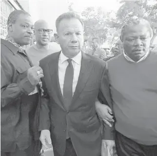  ?? WILFREDO LEE/AP ?? Suspended Broward County Sheriff Scott Israel, center, leaves a news conference on Friday after Gov. Ron DeSantis suspended him, over his handling of last February’s massacre at Marjory Stoneman Douglas High School.