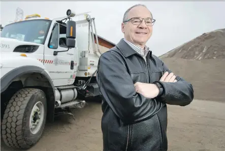  ?? LYLE ASPINALL ?? Roads maintenanc­e manager Bill Biensch stands near a sanding truck and a pile of “pickle,” the informal name for salt-and-brine filled sand, at Calgary’s Roads Building on Wednesday. Financiall­y, the city’s snow-clearing budget is considered to be in...