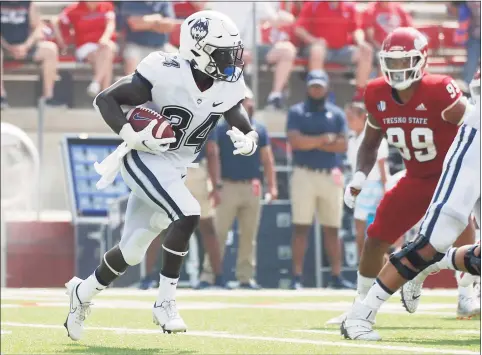  ?? Gary Kazanjian / Associated Press ?? UConn running back Kevin Mensah carries against Fresno State on Aug. 28.